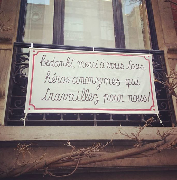 Poster on balcony, which says "Thank you to all the anonymous heroes that work for us!" 