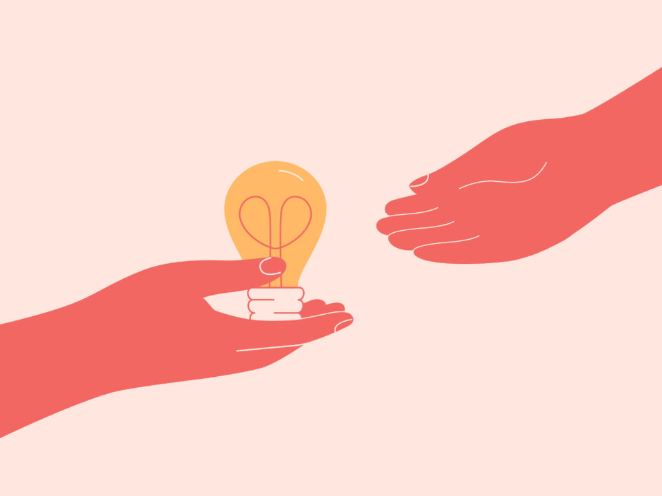 A hand passing a light bulb to another person's hand